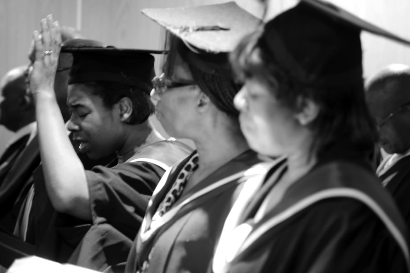 BIBS graduates in prayer during a graduation service